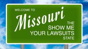 Welcome to Missouri The Show Me Your Lawsuits State green sign.