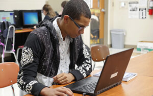 Student working on laptop.