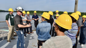 Group photo of construction workers discussing outside.