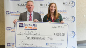 Daniel P. Mehan and girl holding a scholarship check.