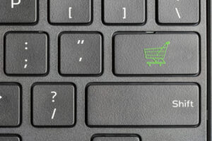 Shopping cart icon on a laptop keycap.