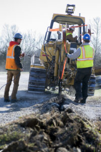 workers laying fiber internet cable