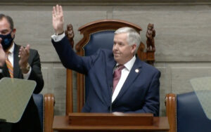 Governor Parson raising his right hand.