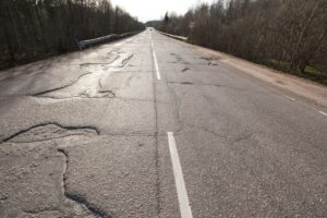 Bad quality road with potholes.