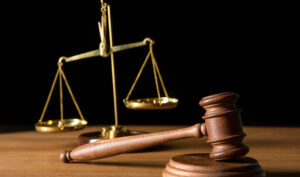 Gavel and scales of justice on table.