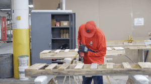 Man assembles glass door at Triad Manufacturing